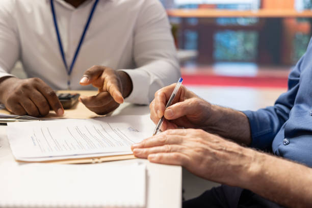 istock Mature person signing the pension plan contract for a retirement package 2178493733