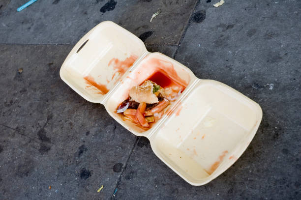 Left over food a burger and chips discarded onto the pavement after a night out