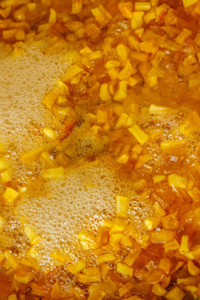 istock sliced yellow apples boiling in syrup during confiture cooking 2178495546