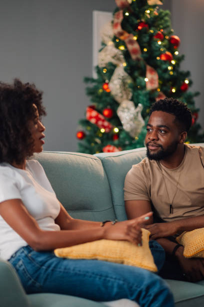 istock Festive home chat between diverse couple seated with Christmas decor 2178496956