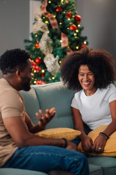 istock Smiling african american couple chatting on sofa adorned with festive decor 2178496966