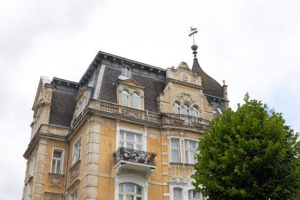 istock A large and impressive building featuring a weather vane placed on its roof 2178500023