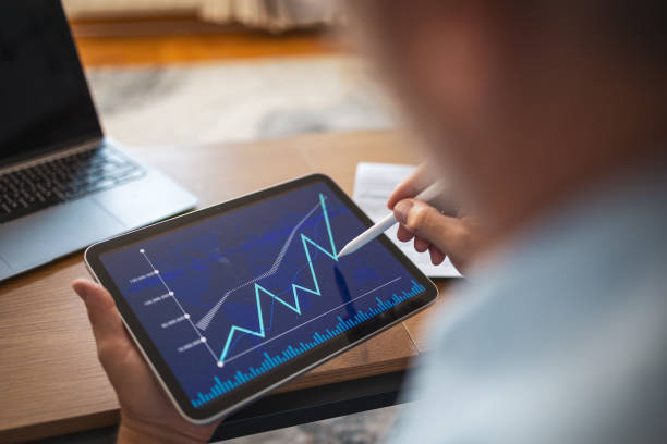 istock Mature man analyzing stock data on tablet at home office 2178501172