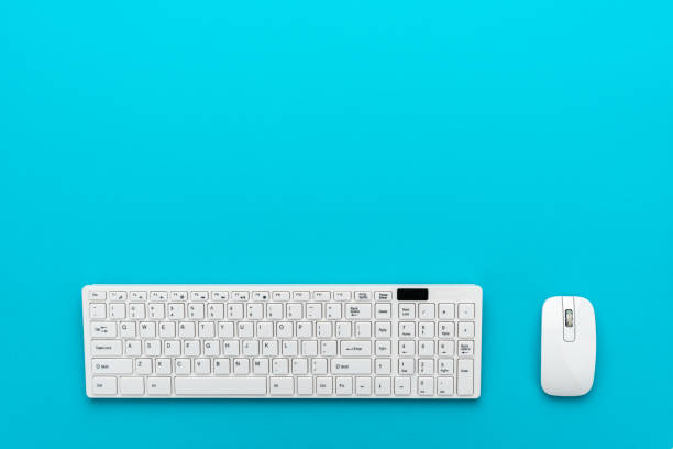 istock Minimalist photo of computer keyboard and mouse on turquoise blue 2178502854