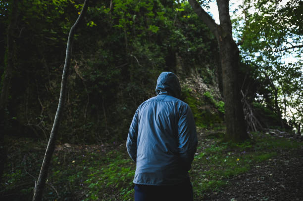istock Man hiking in rain woodland. 2178503778