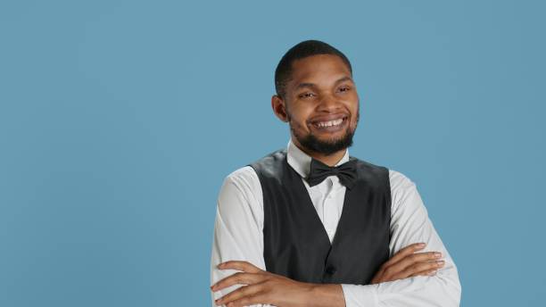 istock Confident cheerful hotel concierge staff poses with arms crossed in studio 2178504207