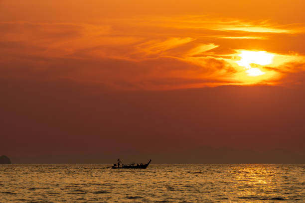 Sun is setting over by horizon on Andaman sea.Phuket Island - Thailand.