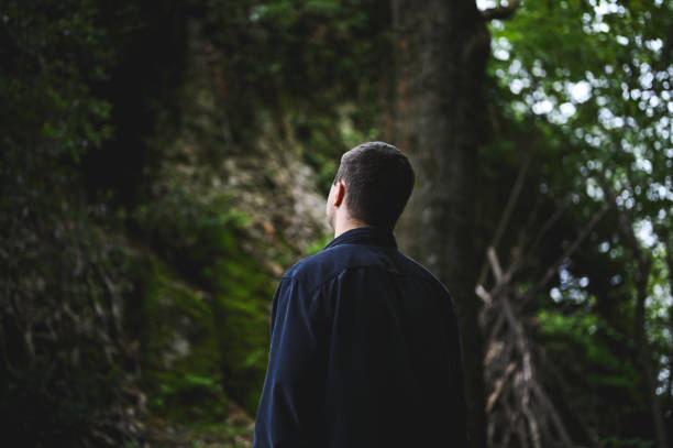 istock Depressive man in woodland. 2178504663