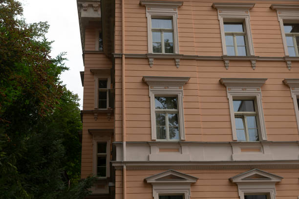 istock A tall building featuring numerous windows alongside trees in the background 2178505027