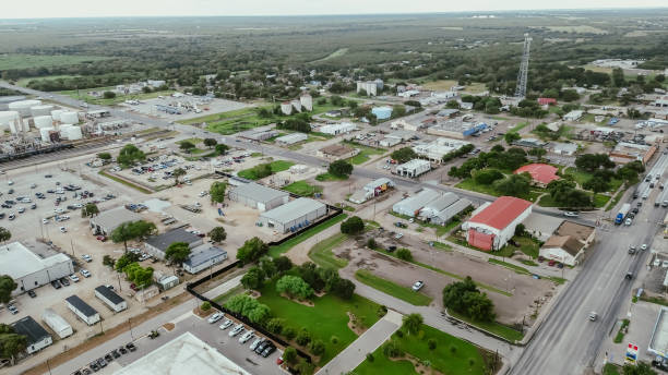 istock Cracking refinery facility, storage tanks and industrial buildings near downtown Three Rivers, US highway 281, Texas, small town mixed of oil gas industry and farmland, ranch, rural scene, aerial 2178506035