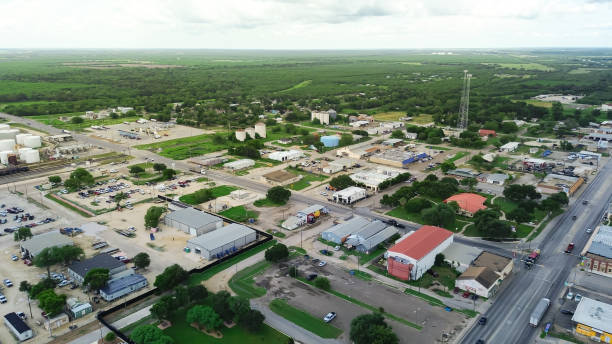 istock Cracking refinery facility, storage tanks and industrial buildings near downtown Three Rivers, US highway 281, Texas, small town mixed of oil gas industry and farmland, ranch, rural scene, aerial 2178506056