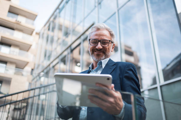 istock Confident businessman using digital tablet outdoors in the city 2178507051