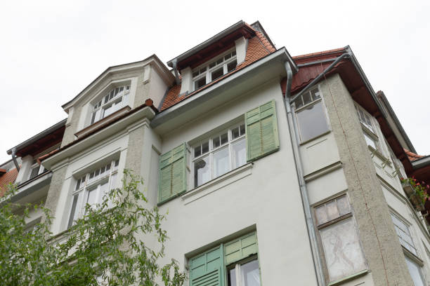 istock There is a large, elegant white building featuring green shutters on its windows 2178507386