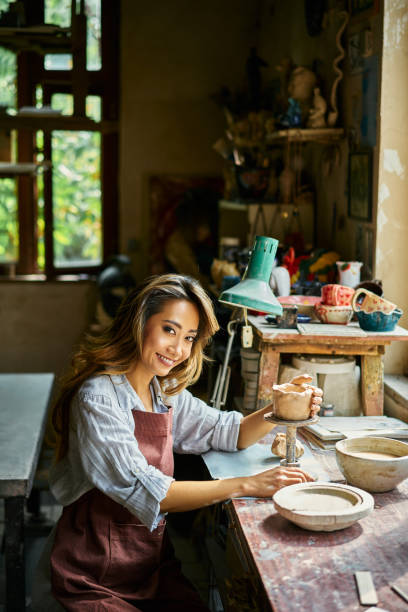 istock Female artist sculpts crafts with ceramic clay at her creative workshop 2178507739