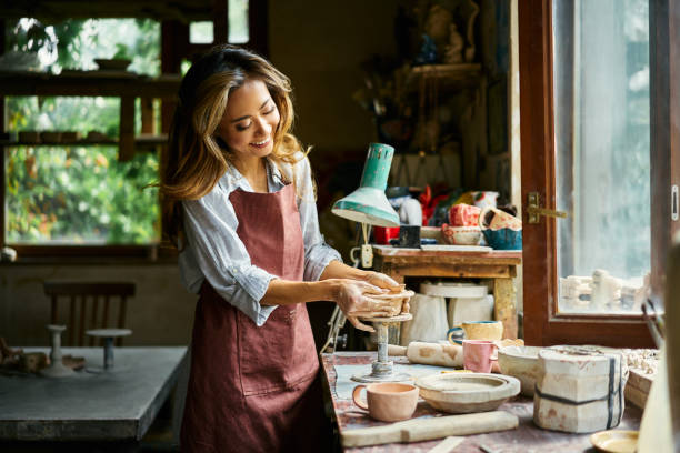 istock Female artist sculpts crafts with ceramic clay at her creative workshop 2178507780
