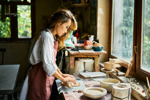 istock Female potter sculpts from clay at her workshop. 2178507788