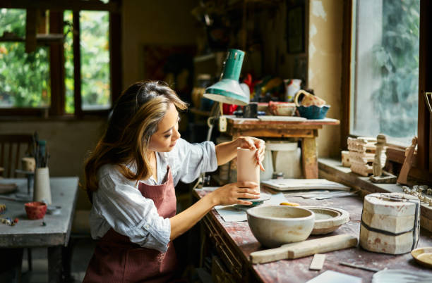 istock Female artist sculpts crafts with ceramic clay at her creative workshop 2178507793
