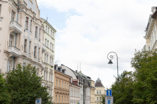 istock A long street lined with numerous buildings and several trees along it 2178509075