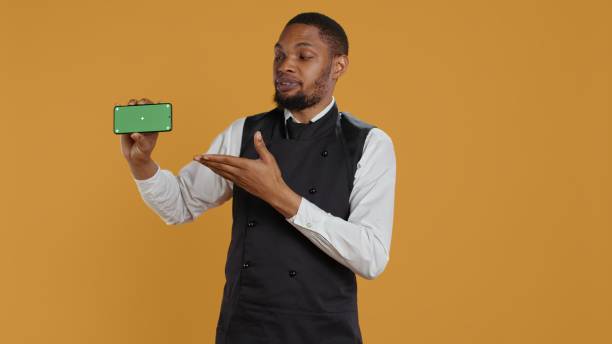 istock Waiter with professionalism holding a phone with isolated mockup display 2178509245