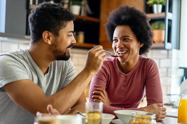 istock Happy african american couple having breakfast together in the kitchen 2178509297