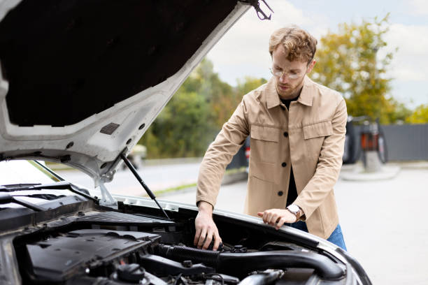 istock Young man inspecting his car engine looking for a breakdown 2178511544