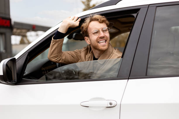 istock Happy businessman waving from car window 2178511679