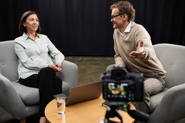 istock Dynamic journalist engages with an expert guest in a lively podcast studio discussion 2178511714