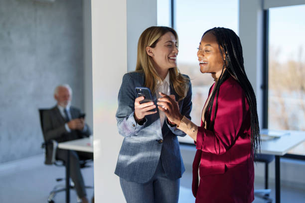 istock Diverse Businesswomen Consulting Smartphone in Office 2178513193