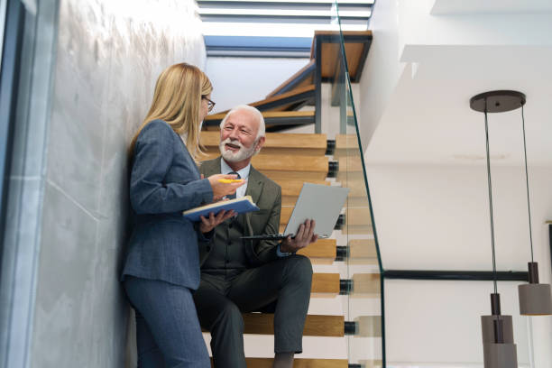 istock Senior Executive and Businesswoman Collaborate in Contemporary Office 2178513402