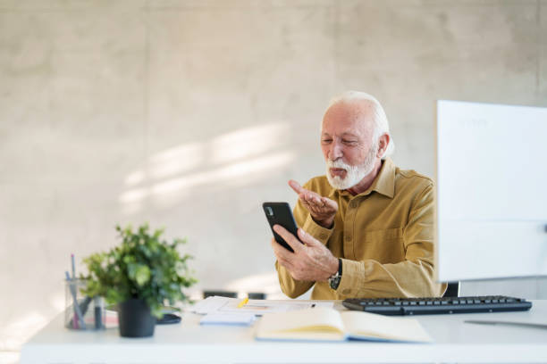 istock Senior Business Executive Engaged with Smartphone 2178513434
