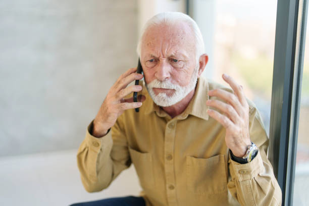 istock Senior Business Executive Engaged in Smartphone Conversation 2178513496
