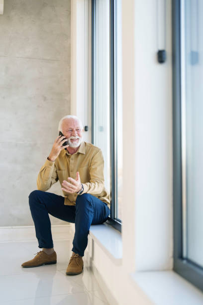 istock Elderly Business Executive Engaged in Smartphone Conversation 2178513506