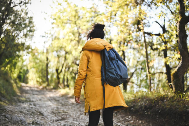 istock Woman with backpack hiking on footpath 2178514131
