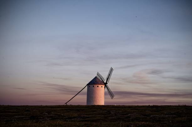 istock Lone windmill stands silhouetted against a dramatic sunset 2178514361