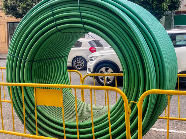 View of barricades and rolled plastic tubes in street being repaired in the city of Valencia, Spain