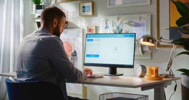 istock Back view of man entering prompt in AI image generator on computer 2178516196