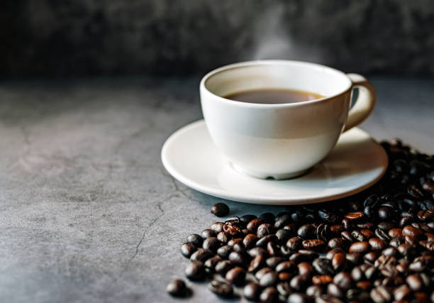 istock Americano coffee cup and roasted coffee beans falling in a burlap sackon gray background, Black coffee cup aromatic 2178517637