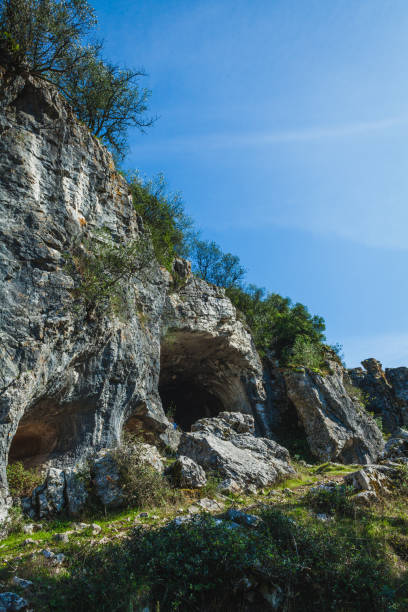 istock a dramatic limestone cliff with natural caves embedded within it, likely part of the Buracas do Casmilo area in Portugal. The weathered rock formations are a mix of light gray and brown tones 2178518775