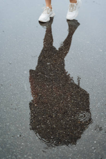istock When a persons shadow falls on a pool of water, it creates a beautiful reflection, capturing the moment in a mesmerizing and captivating way that enchants the onlookers 2178520898