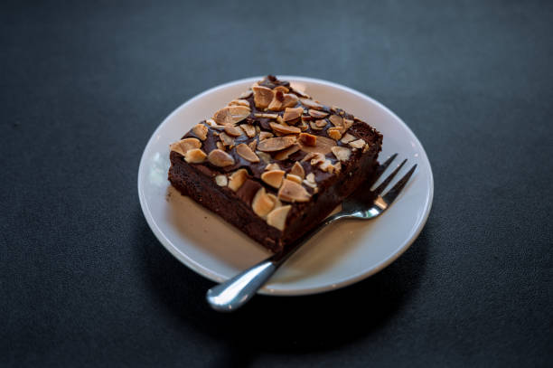 A brownie in a plate on a black table