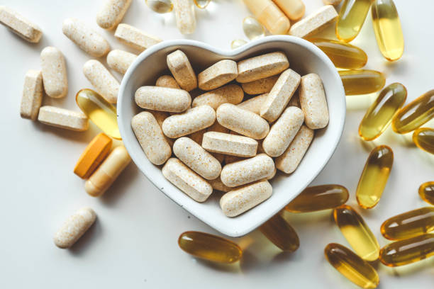 Tablets and vitamins on white background, banner advertising, pharmaceuticals