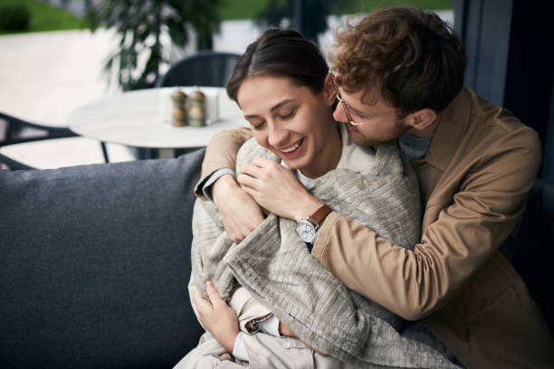 istock Young man embracing and comforting girlfriend on a date at a cafe 2178532704