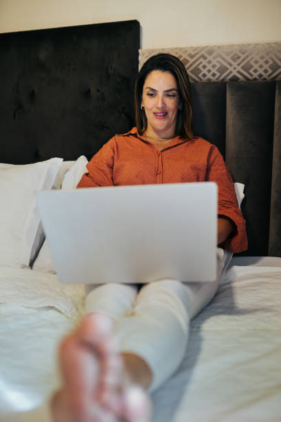 istock Business woman using laptop in a hotel room 2178533347