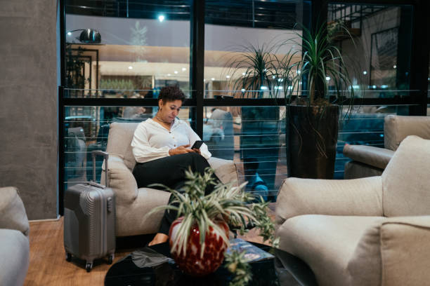 istock Business woman using cell phone in a hotel hall 2178533942