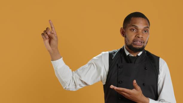 istock Friendly restaurant staff indicating direction to left or right sides 2178534404