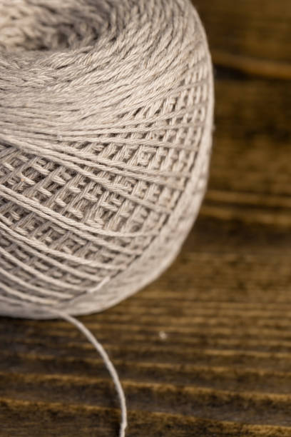 sewing threads in production closeup, a new skein of grey thread is used for sewing