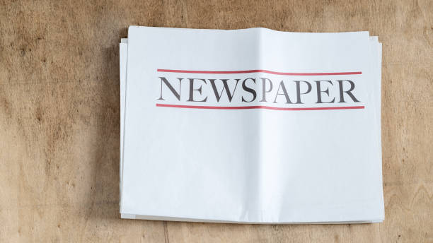 istock Newspaper on wooden background 2178535620