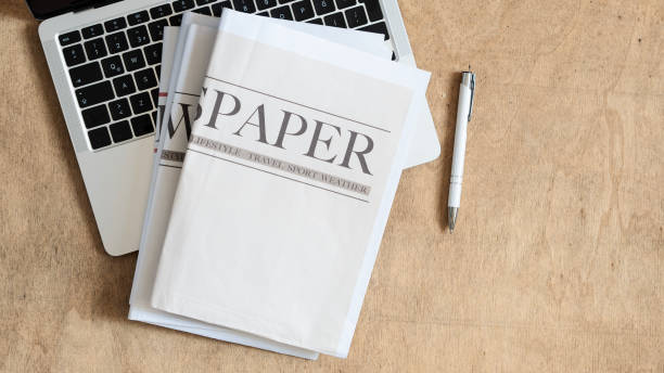 istock Newspaper on wooden background 2178535646