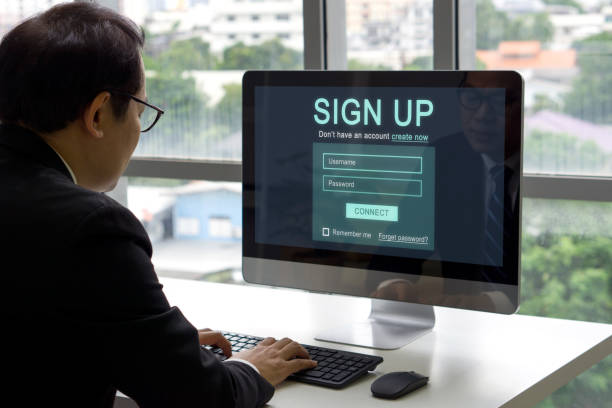 istock Digital Life Exploration: A focused man engrossed in creating his identity online, registering for an account on his computer. 2178538864