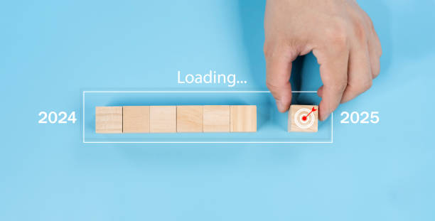 istock Hand assemble wooden block cube to update technology downloading tool bar status from 2024 to 2025. 2178540630